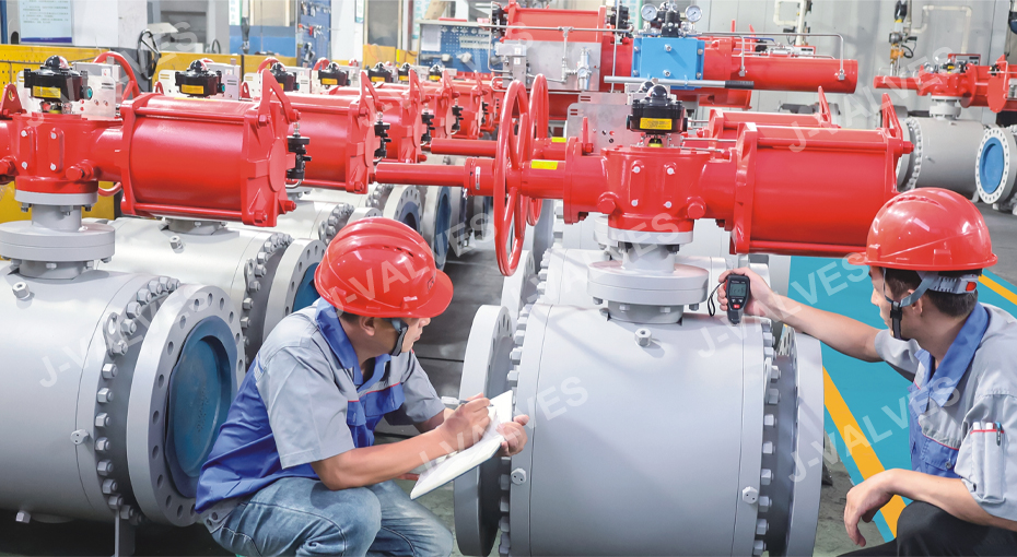 J-VALVES engineers checking large trunnion ball valves with actuators during an OEM batch inspection before dispatch